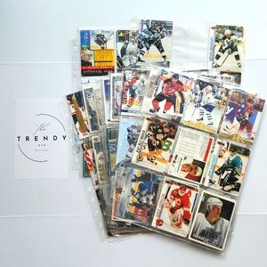 Large stack of vintage hockey cards in protective sleeves/ 90s trading cards